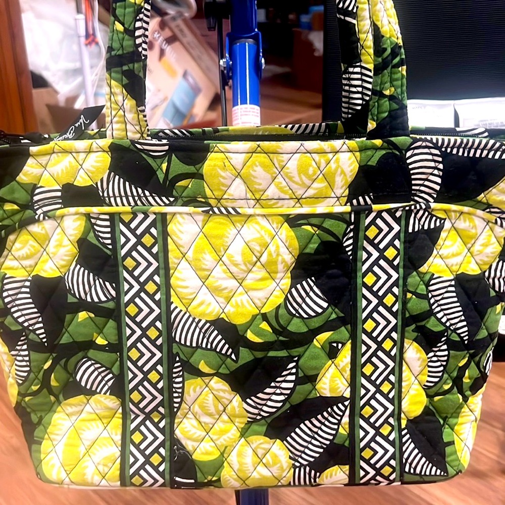 Small Vera Bradley tote with various shades of greens with black background